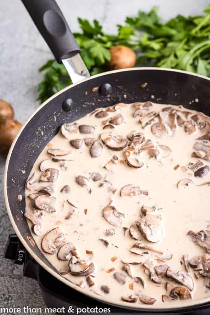 Heavy cream added to the pan to create the sauce.