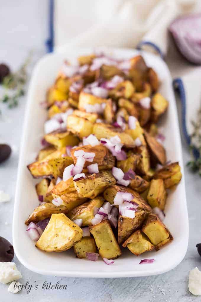 Potato Feta Salad Roasted potatoes topped with diced red onion.