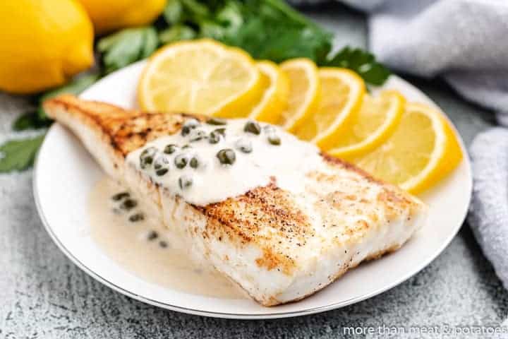 Pan seared halibut garnished with fresh lemon.