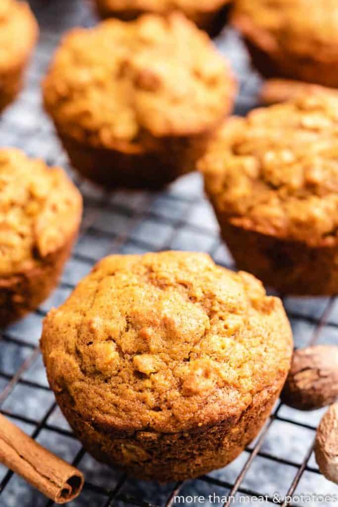 The oat muffins sitting on a black rack.