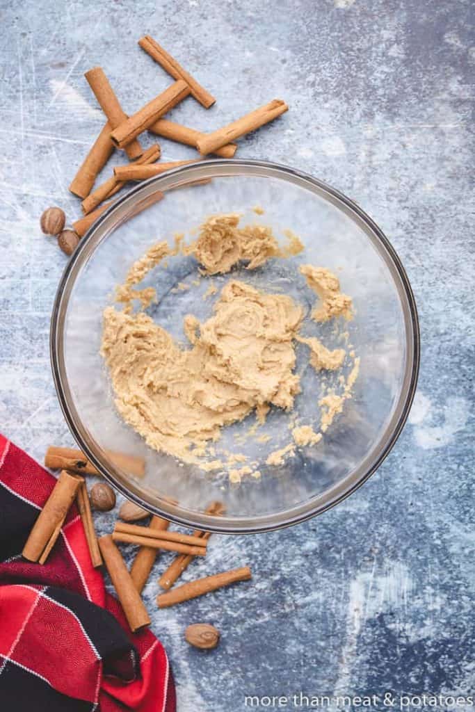 Butter and brown sugar combined in a mixing bowl.