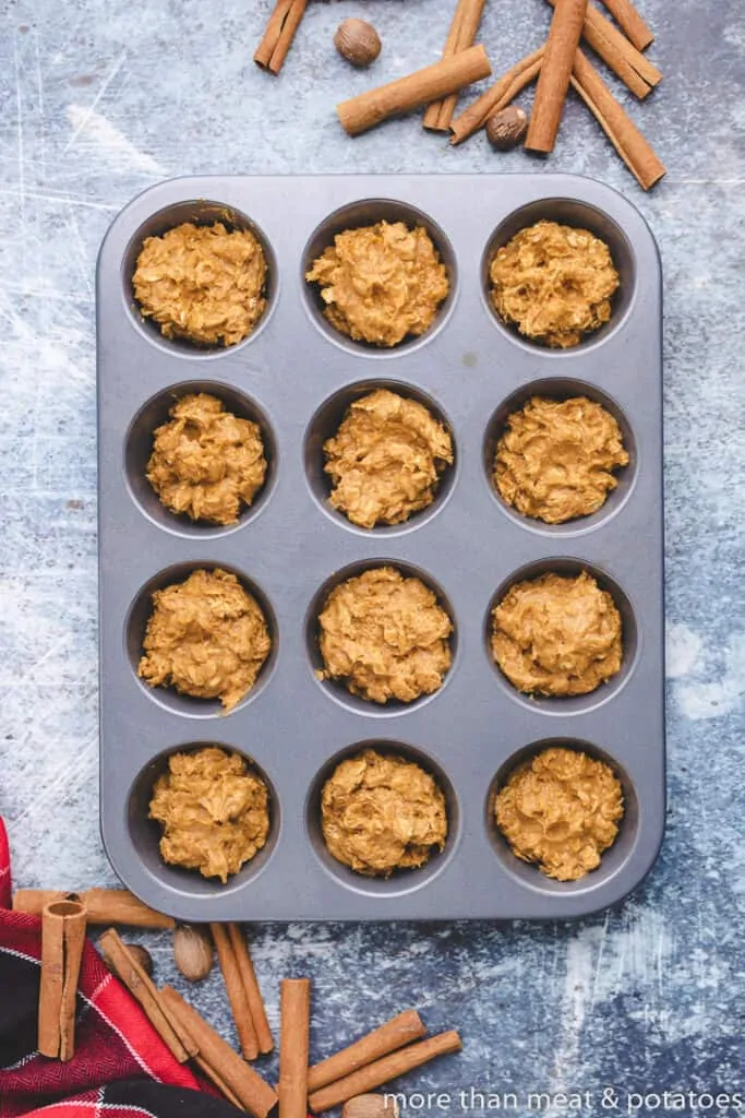 The pumpkin muffin batter transferred to a muffin tin.