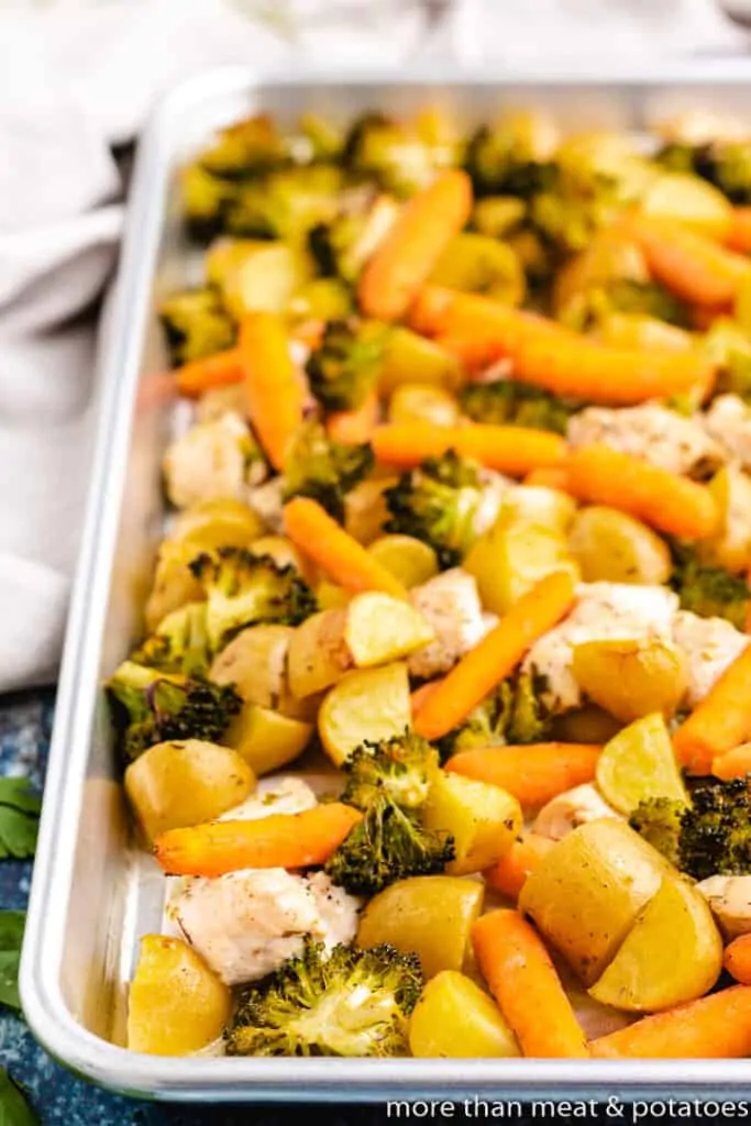 Roasted meat and vegetables on a sheet pan.