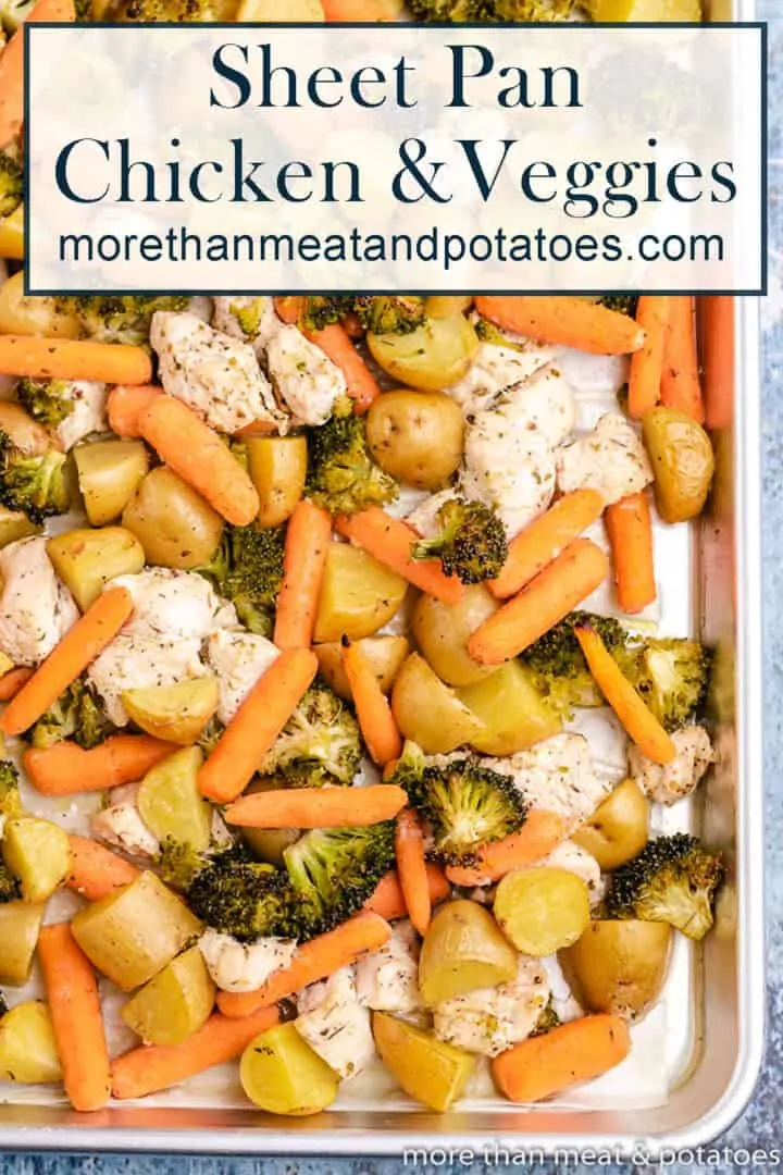 Aerial view of baked chicken and vegetables on a sheet pan.