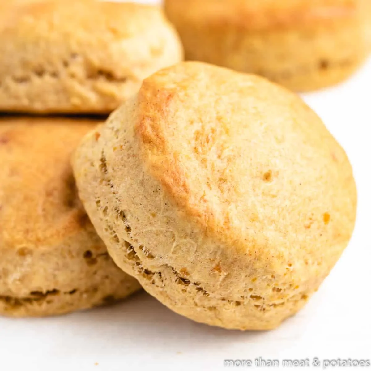 Four sweet potato biscuits on a counter-top.