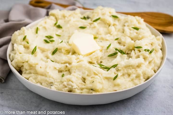 Creamy brie mashed potatoes topped with butter.