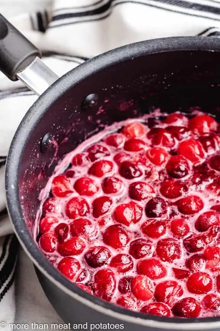 Easy Cranberry Fruit Salad The berry syrup cooking in the saucepan.