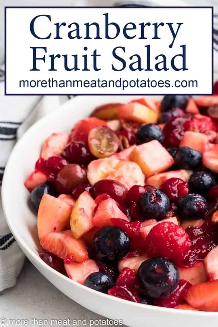 A fruit salad tossed with a cranberry syrup.