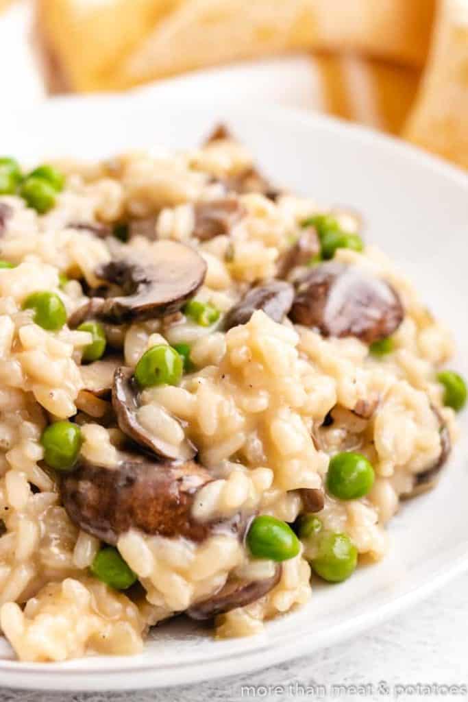 The creamy rice and mushrooms in a bowl.