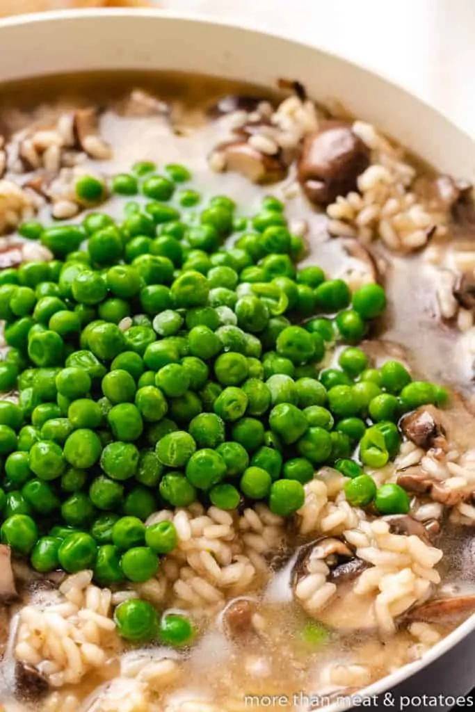 Frozen peas have been added to the mushrooms.