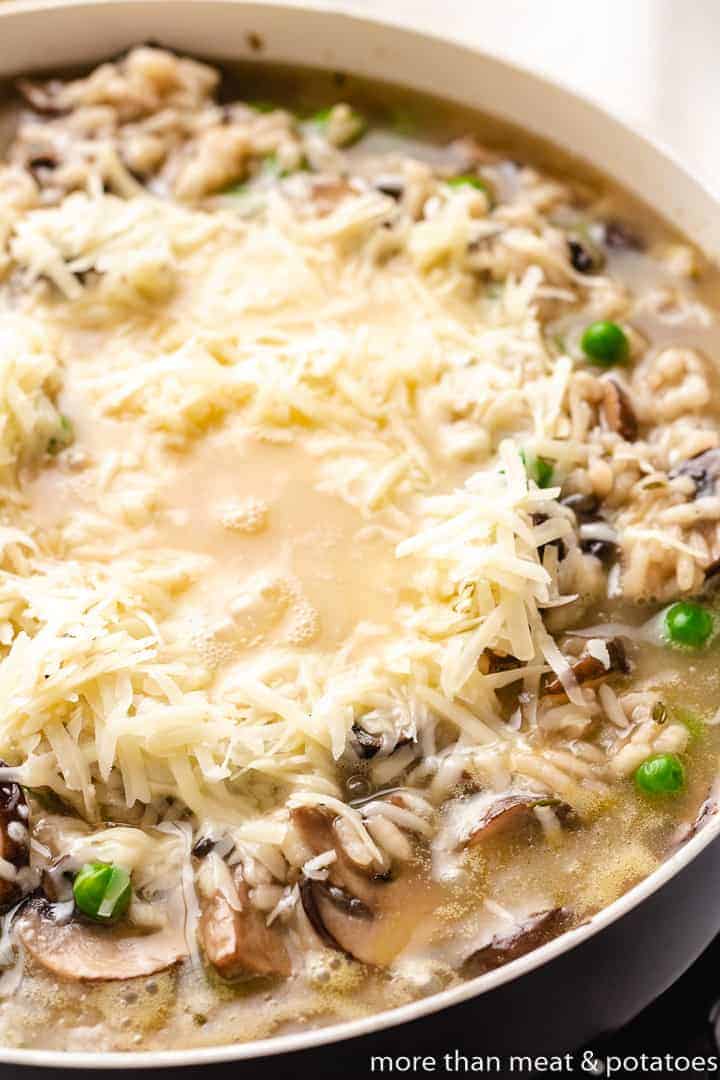 Shredded Parmesan cheese added to rice and peas.