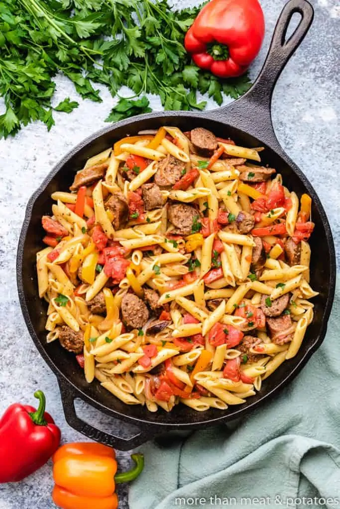 The cooked pasta noodles added to the skillet.