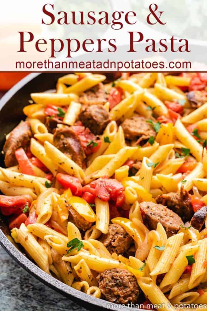 The finished sausage and peppers pasta in a skillet.