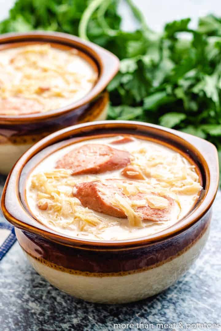 Two brown bowls filled with bean soup.