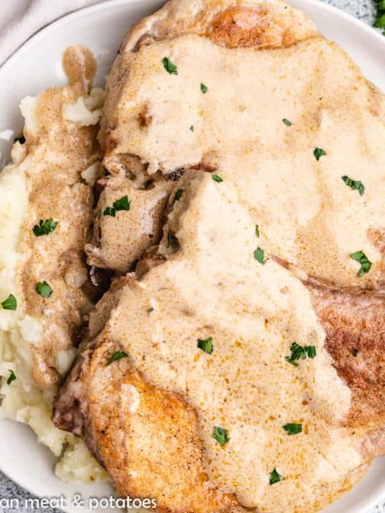 An aerial view of the sour cream pork chops with gravy.