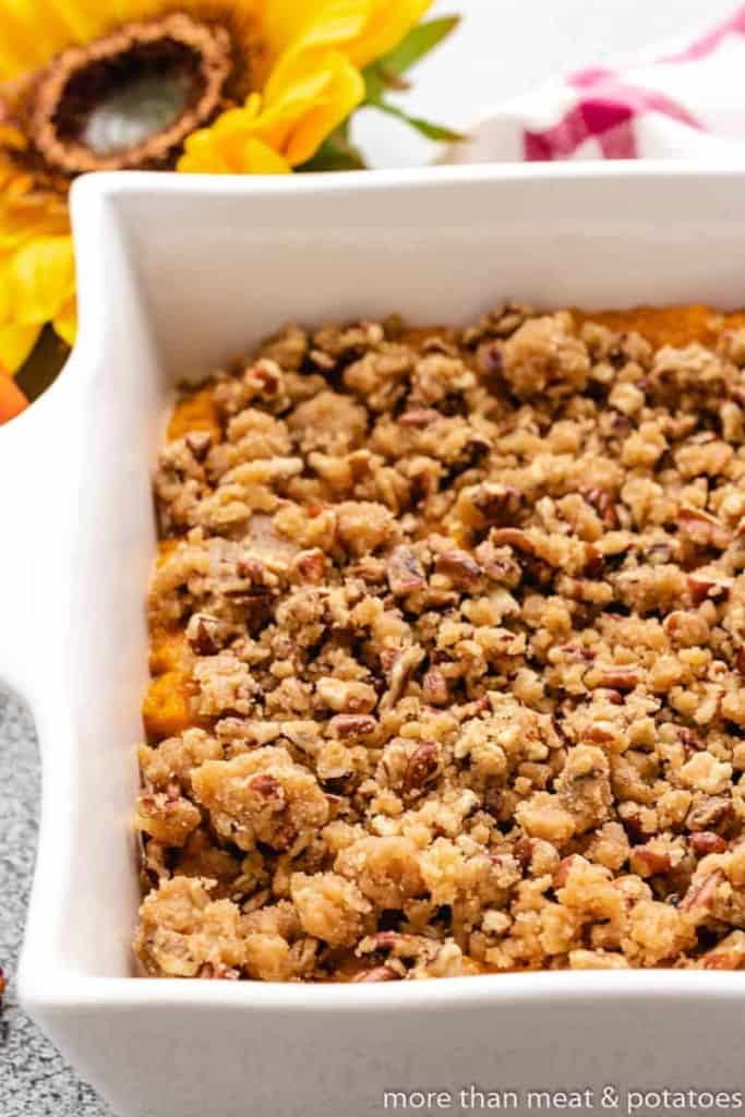 Sweet Potato Casserole with Pecan Streusel A close-up view of the pecan topping on the casserole.