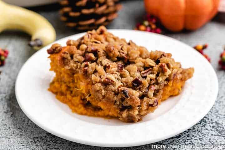 Sweet Potato Casserole with Pecan Streusel A slice of the sweet potato casserole on a plate.