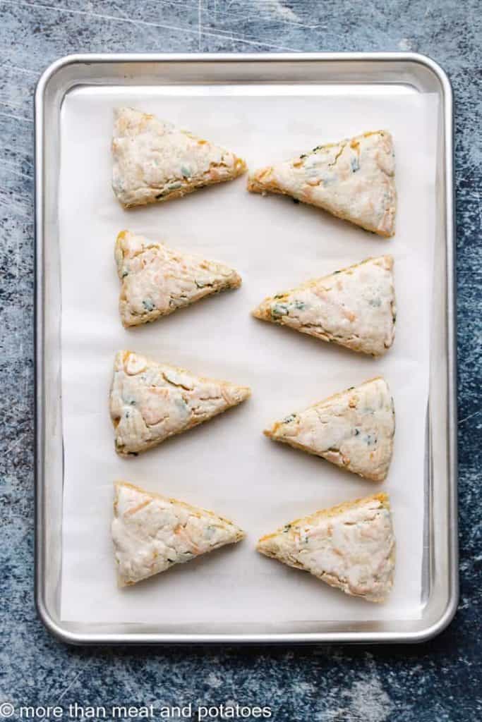 Triangular sections of dough transferred to a sheet pan.