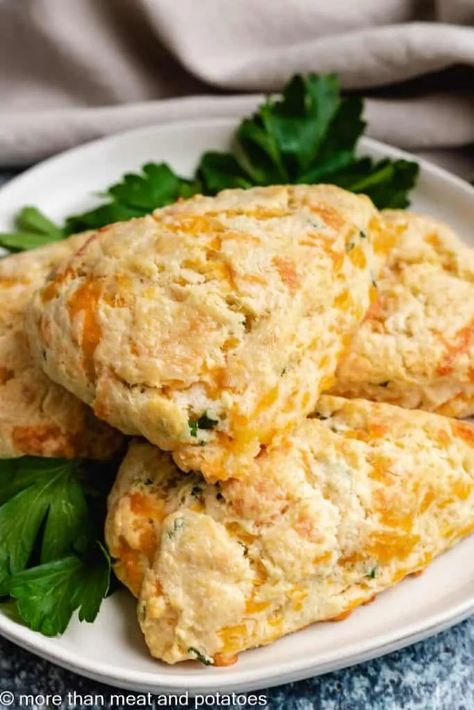 Four fresh baked scones on the serving plate.