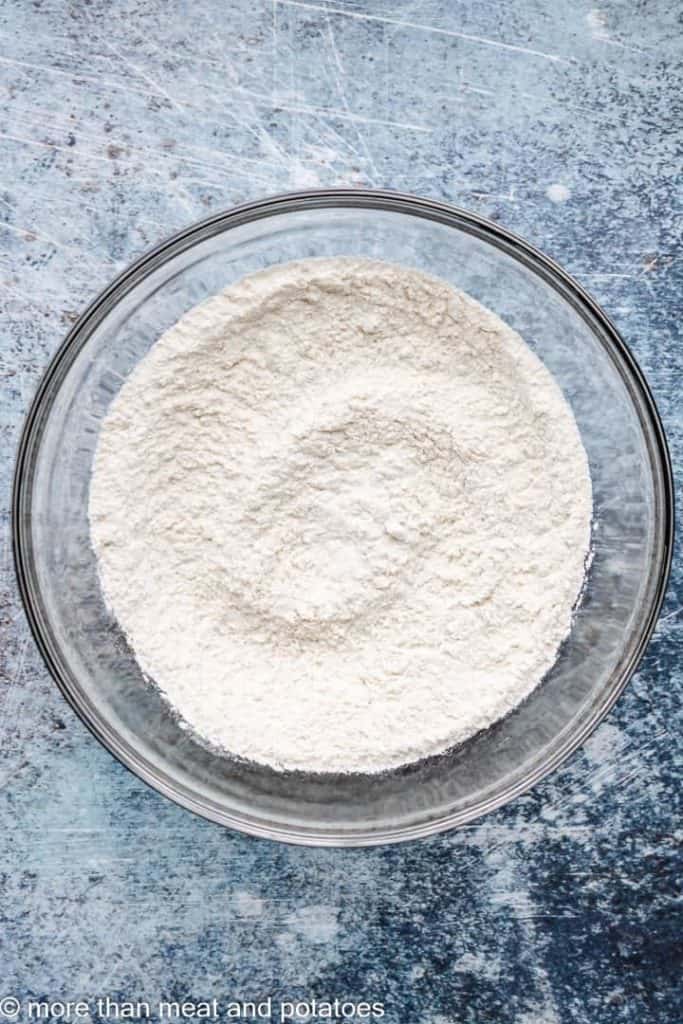 Flour and other dry ingredients combined in a mixing bowl.