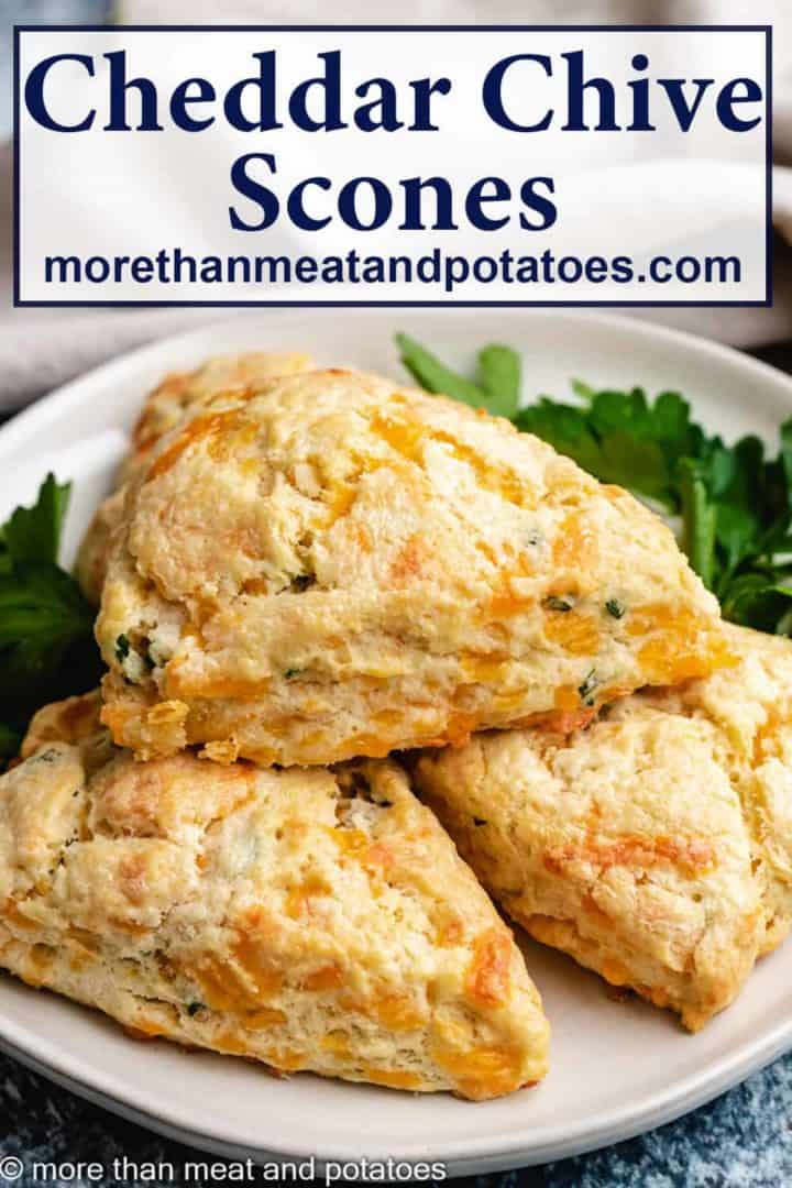 Cheddar chives scones served on a white plate.