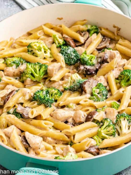 The finished chicken mushroom broccoli pasta in a skillet.