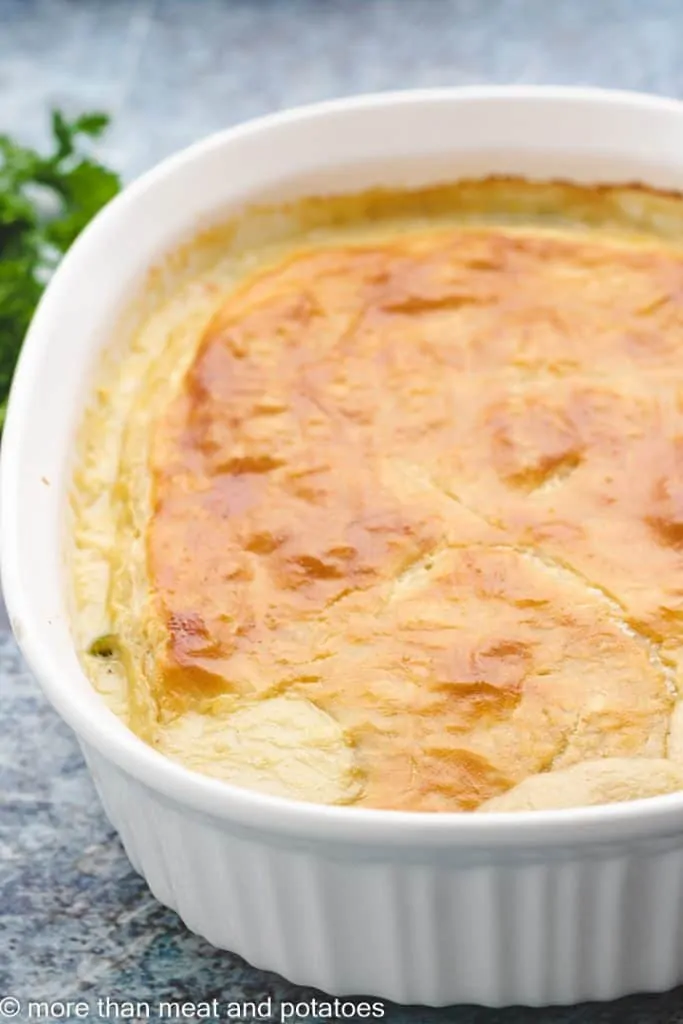 An angled view of the meat pie in a casserole dish.