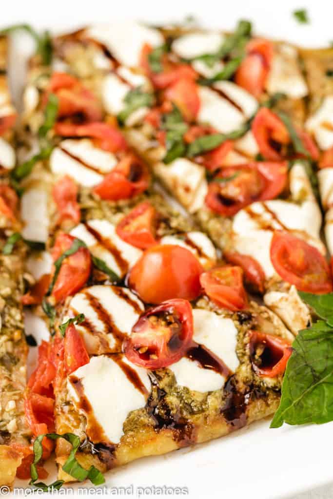 Close up of tomato mozzarella basil flatbread.