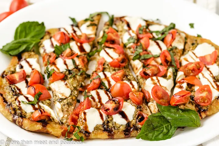 Sliced flatbread with tomatoes and mozzarella.