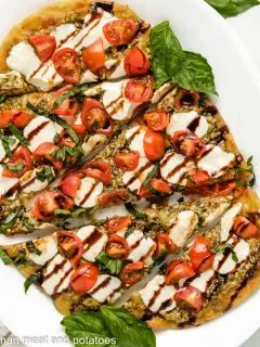 Top down of Caprese Flatbread on a plate.
