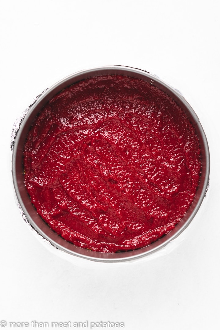 Layer of cranberry filling on top of a graham cracker crust.