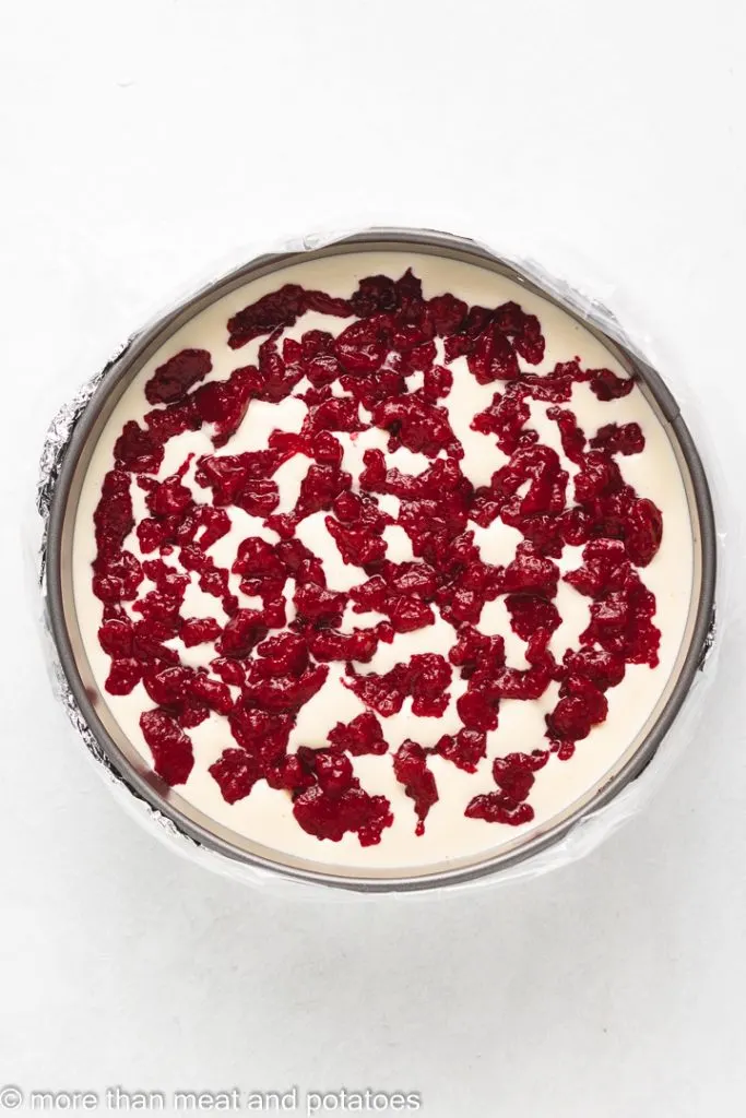 Top down view of cranberry filling in a cheesecake.