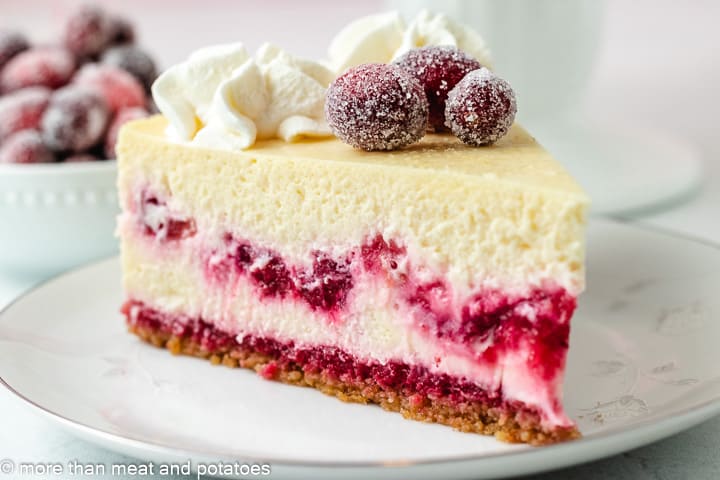 Slice of cranberry cheesecake on a plate.