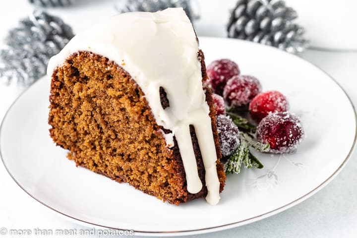 Slice of gingerbread bundt cake on a plate.