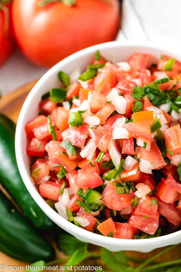 Top down view of pico de gallo recipe in a bowl.