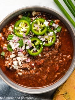Top down photo of chili in a gray bowl.
