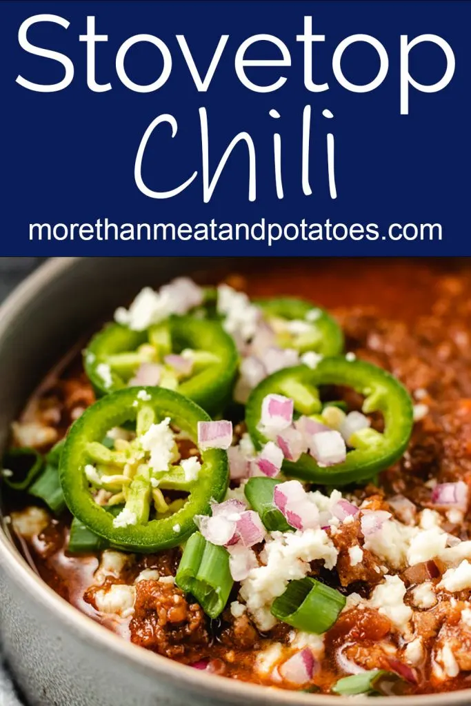 Homemade chili in a bowl with jalapenos.