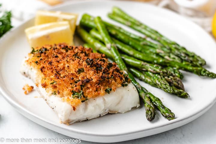 Oven baked fish with panko topping on a gray plate.
