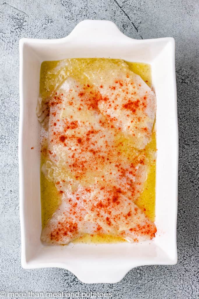 Arial view of uncooked flounder in a baking dish.