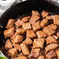 Close up photo of Cajun steak bites in a pan.