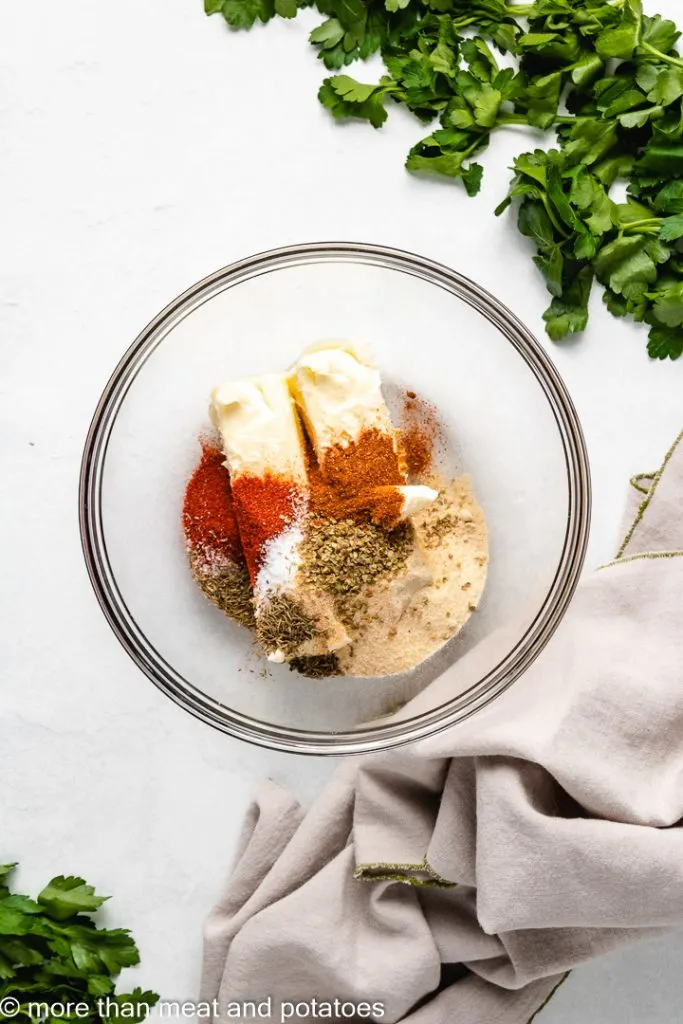 Softened butter and seasonings in a bowl.