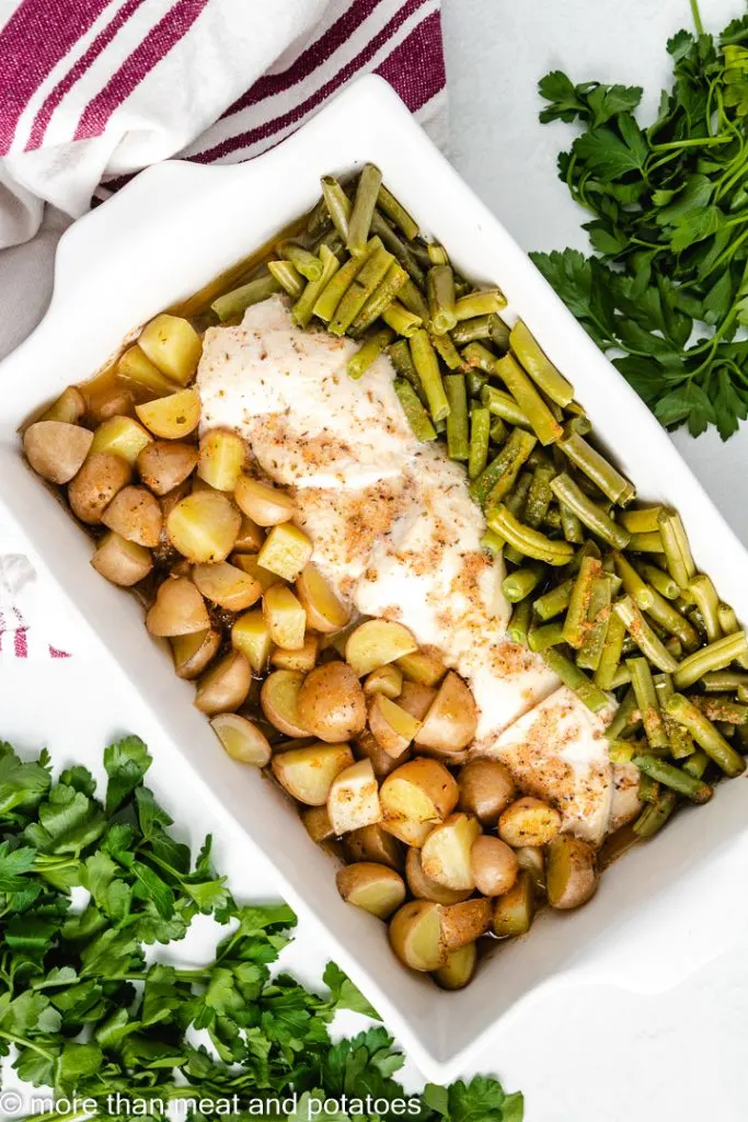 Top down view of seasoned chicken and veggies.