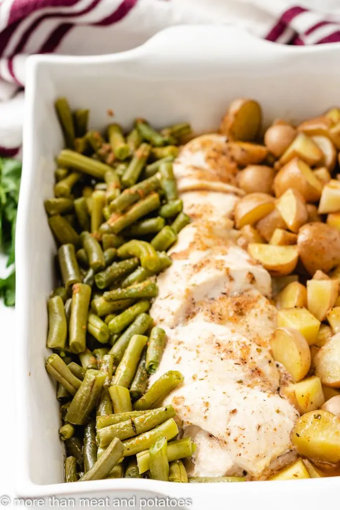 Close up of baked chicken with veggies.