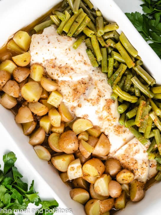 Baked chicken green beans and potatoes with seasoned butter.