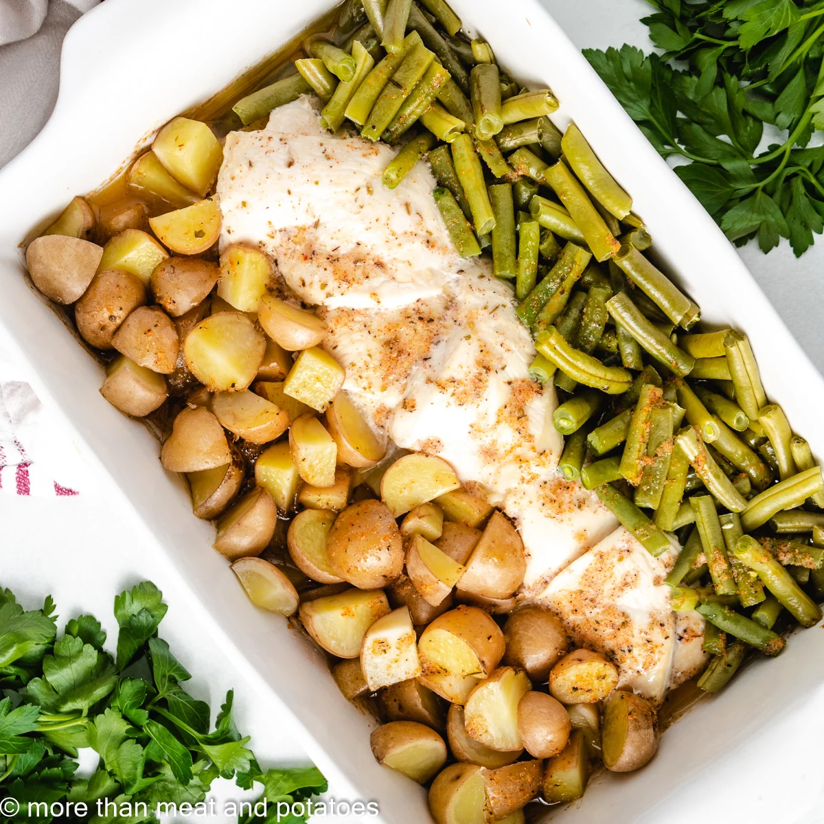 Baked chicken green beans and potatoes with seasoned butter.