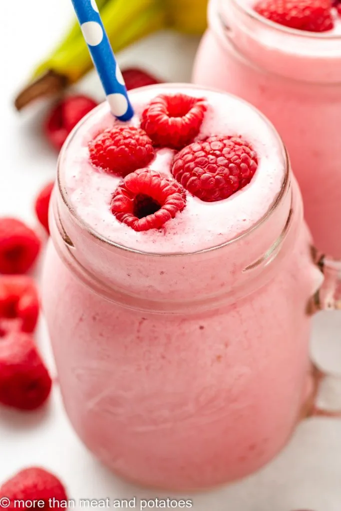 Raspberry smoothie in a glass mug.