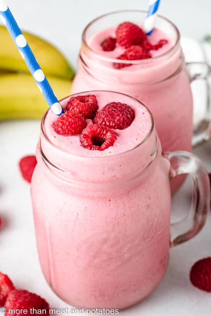 Raspberry smoothies in glass mugs.