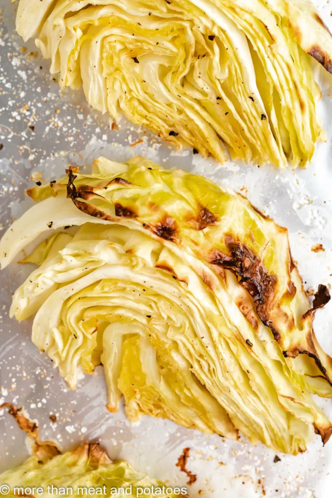 Roasted cabbage wedge on a baking sheet.