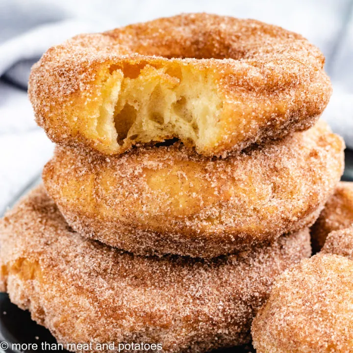 Three stacked donuts with donut holes.