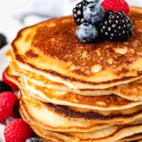 Stack of sourdough pancakes with blueberries.